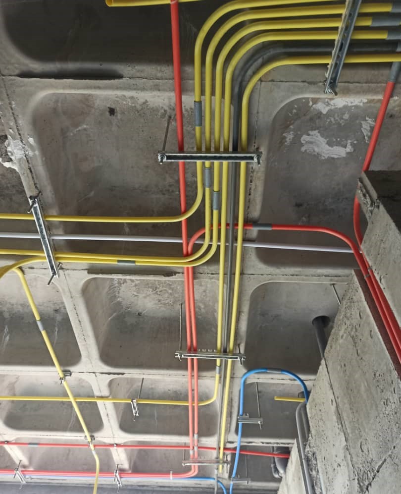 Electrical conduit piping installation in progress at a building construction site