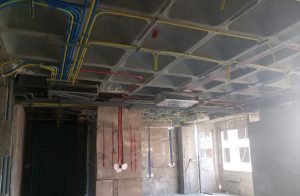 FCU piping installation in progress for HVAC system during building construction