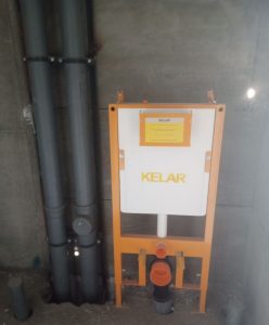 Installation of wall-hung toilet frame and plumbing system during mechanical works